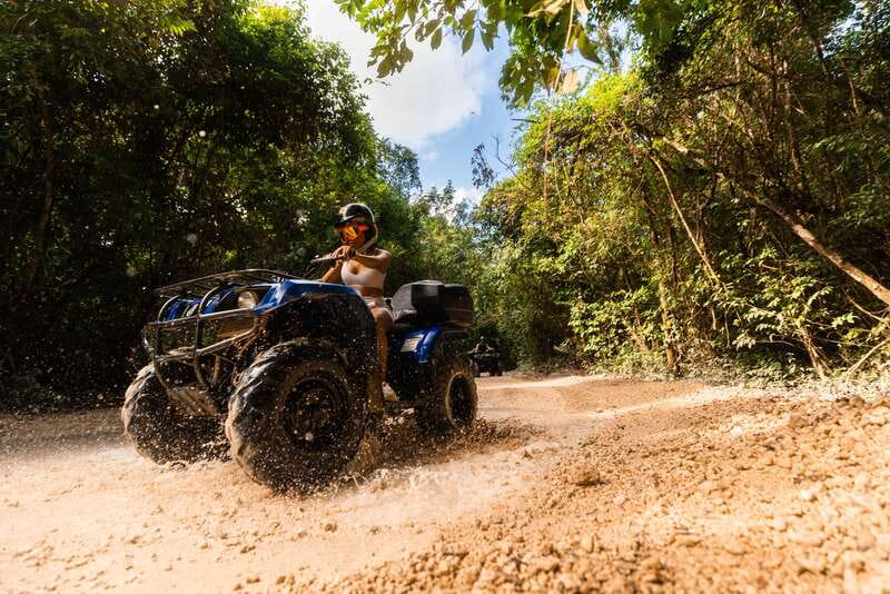 Cancun: Jungle ATV Tour, Ziplining, and Cenote Swim - ATV riding on dusty and muddy tracks